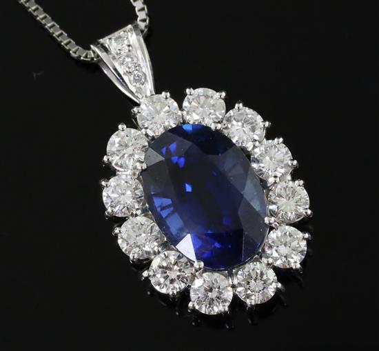 A platinum-set sapphire and diamond oval cluster pendant on 18ct white gold chain, pendant 28mm overall.
